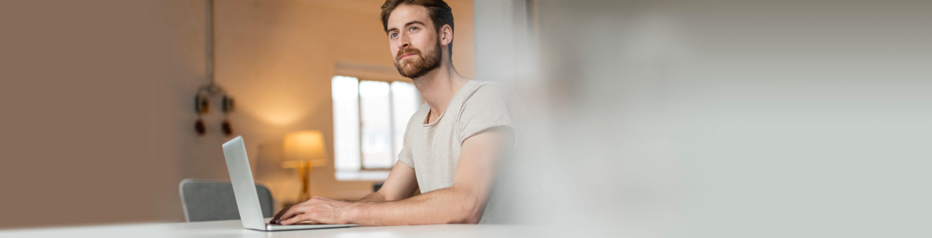 Image of a man working from a laptop